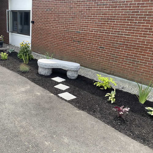 Commercial planting with bench.
